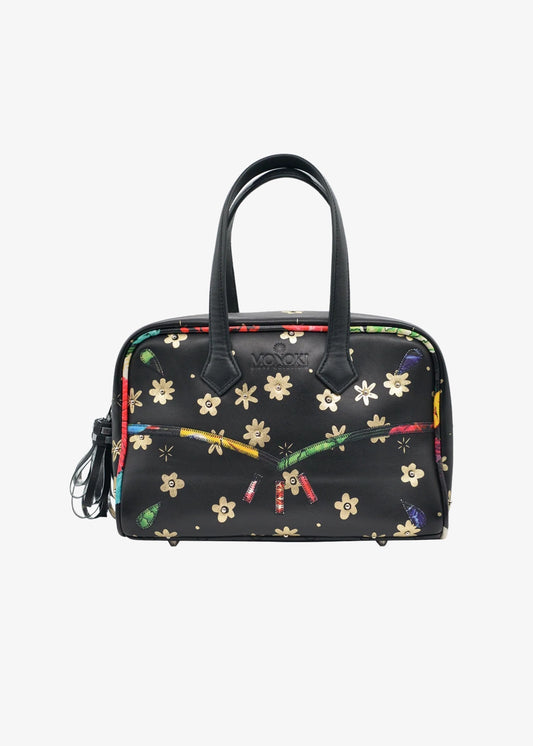 A black dome-shaped handbag with a colorful floral and ribbon print, featuring two black top handles and a small tassel zipper pull.